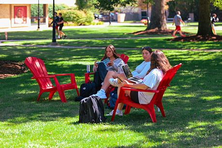 Students lounging outside. Links to Tangible Personal Property