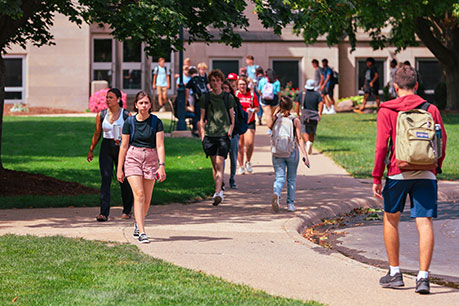 Students walking outside. Links to Gifts from Retirement Plans